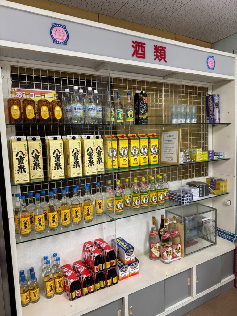 「泡盛ありますか?」にしっかり応える品揃え。地元銘柄がそろった森乃商店の誇りです。 Looking for Awamori? This shelf says yes – packed with local Okinawan favorites.